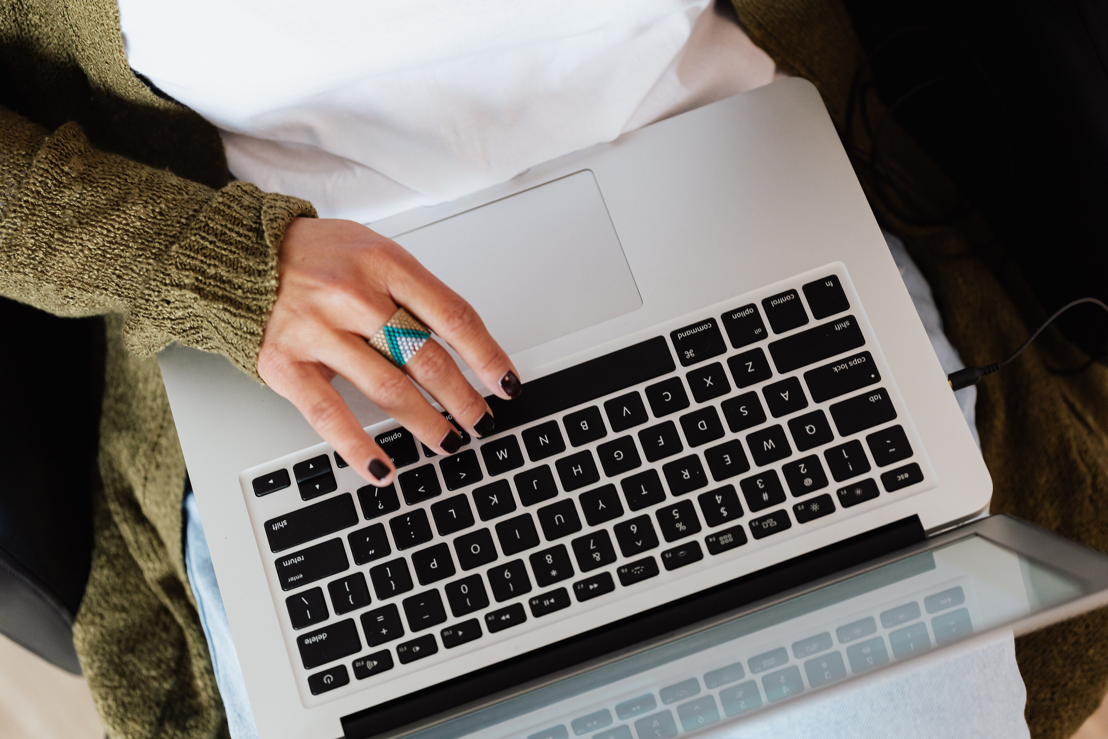Crop woman typing on laptop keyboard